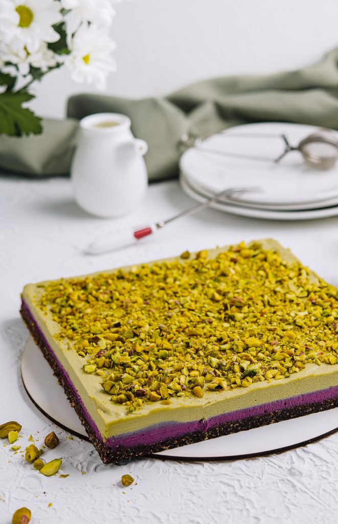 Pistachio cake topped with diced pistachios for bakery production